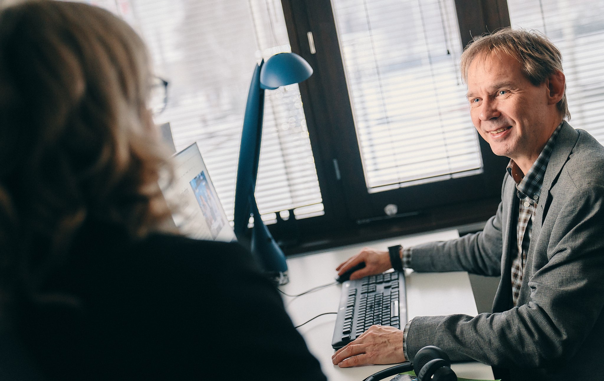 Two people in a meeting room.