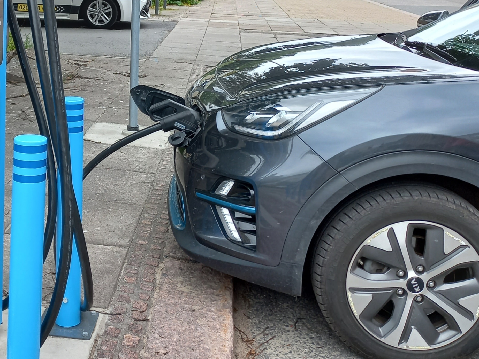 Electric car charging on the street.